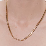woman wearing gold cuban link chain necklace layered