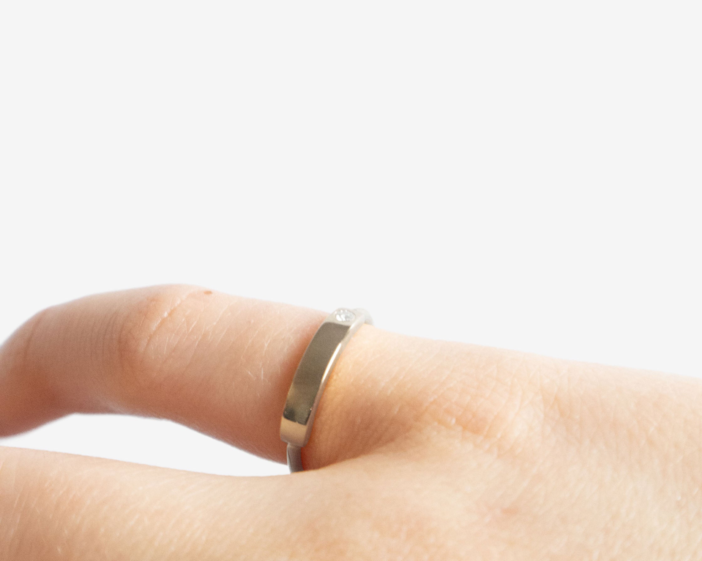 Close up sterling silver ring with diamond sener besim