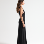 model wearing sener besim black sleeveless dress with open back