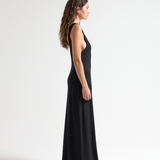 model wearing sener besim black sleeveless dress with open back