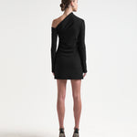 A model wearing a black asymmetric neckline, long-sleeved, mini-length dress by sener besim