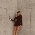 Woman in a brown dress standing by sener besim