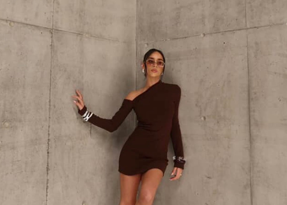 Woman in a brown dress standing by sener besim