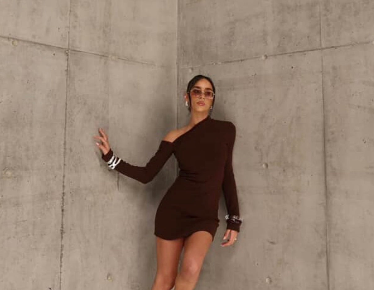 Woman in a brown dress standing by sener besim
