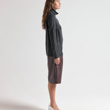 Model wearing relaxed fit blouse with high neck by sener besim