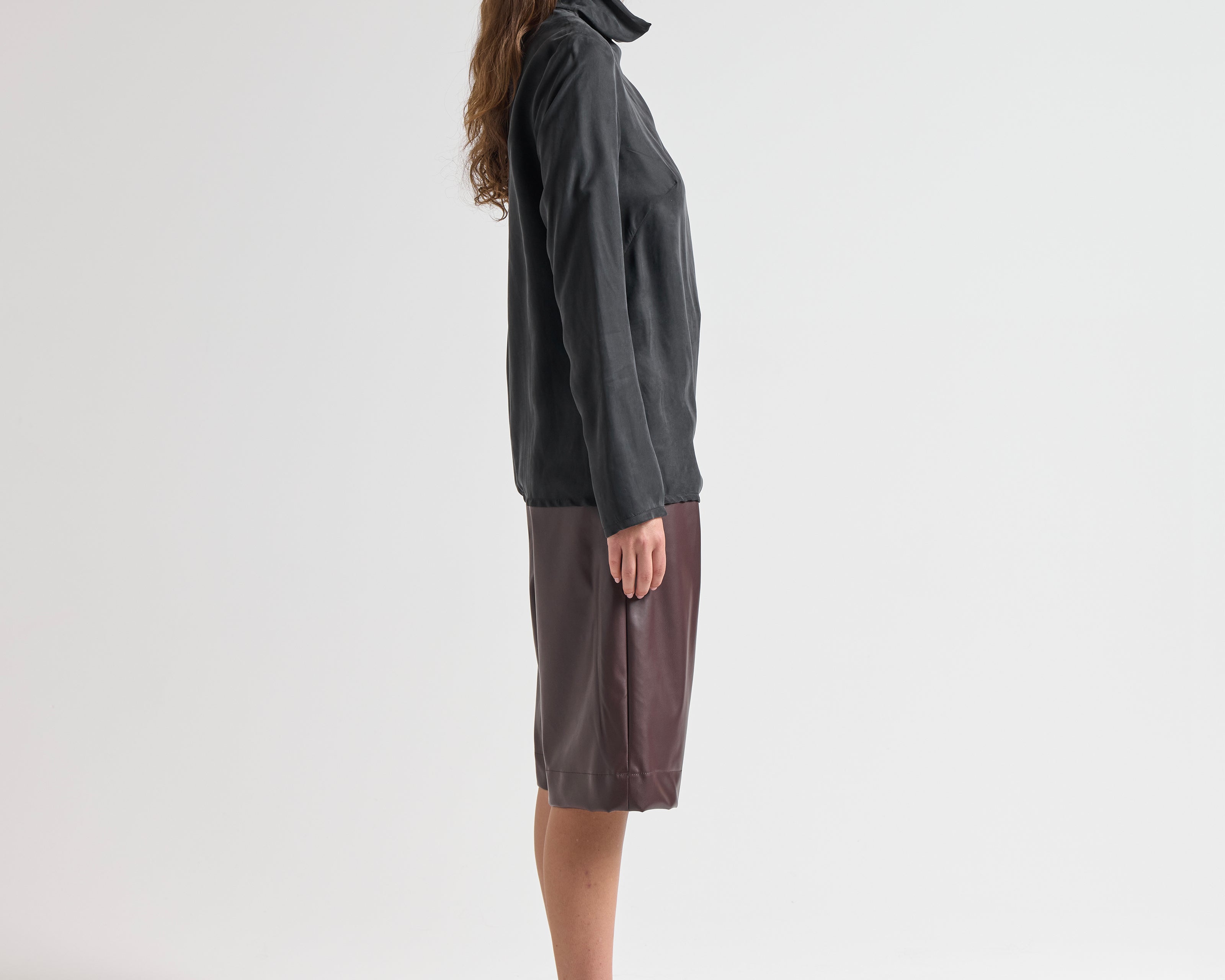 Model wearing relaxed fit blouse with high neck by sener besim