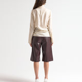 sener besim high neck relaxed top in cream worn by model 