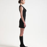 side view of model wearing black one shouldered dress with an asymmetric neckline by sener besim