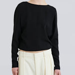model wearing boatneck shirt in black with relaxed fit by sener besim