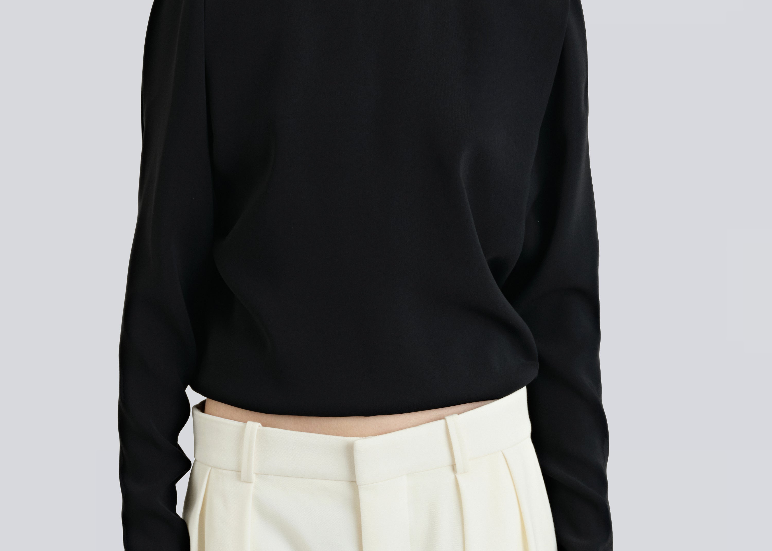 model wearing boatneck shirt in black with relaxed fit by sener besim