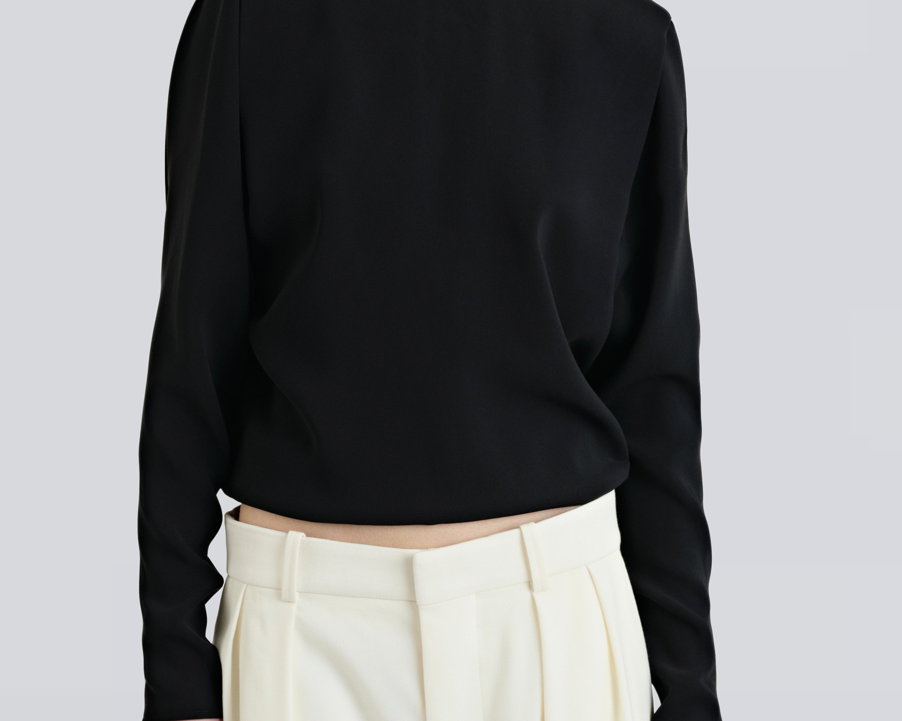 model wearing boatneck shirt in black with relaxed fit by sener besim