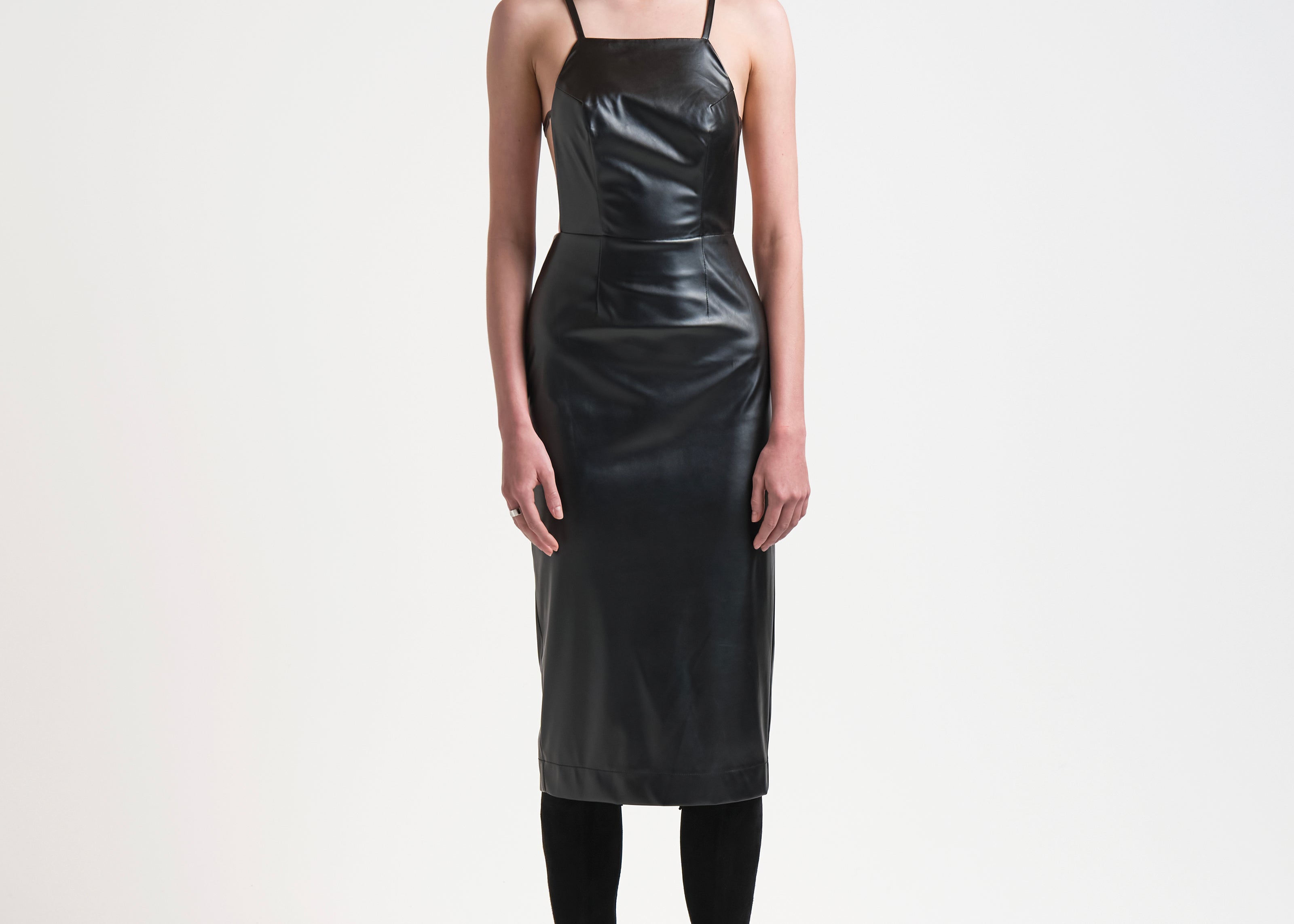 bared back leather apron style leather dress on model by sener besim