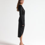 side view of model in sener besim mid length split front skirt 