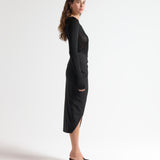 side view of model in sener besim mid length split front skirt 