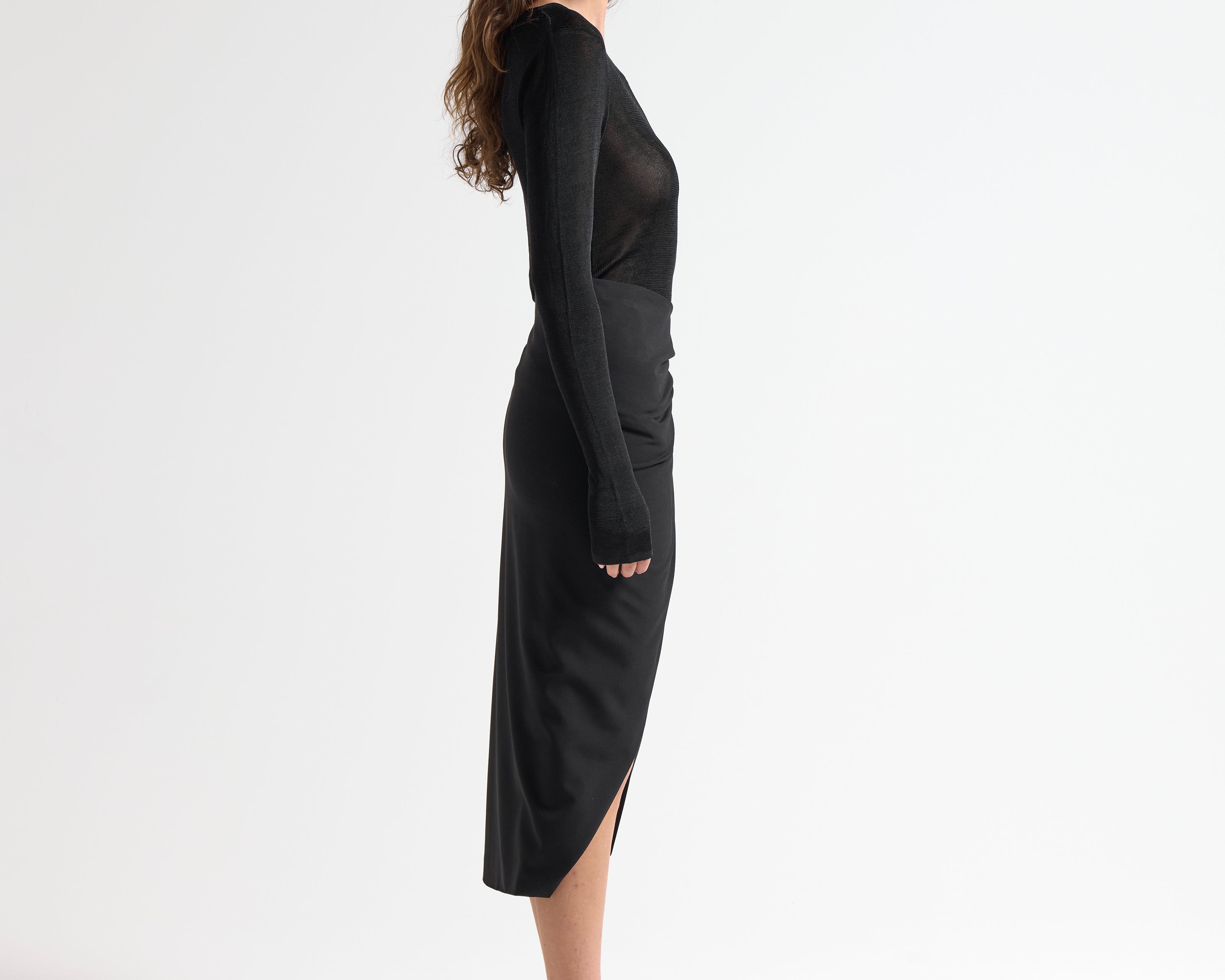side view of model in sener besim mid length split front skirt 