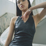 Vegan leather halter neck mini dress with ruching close up — Şener Besim