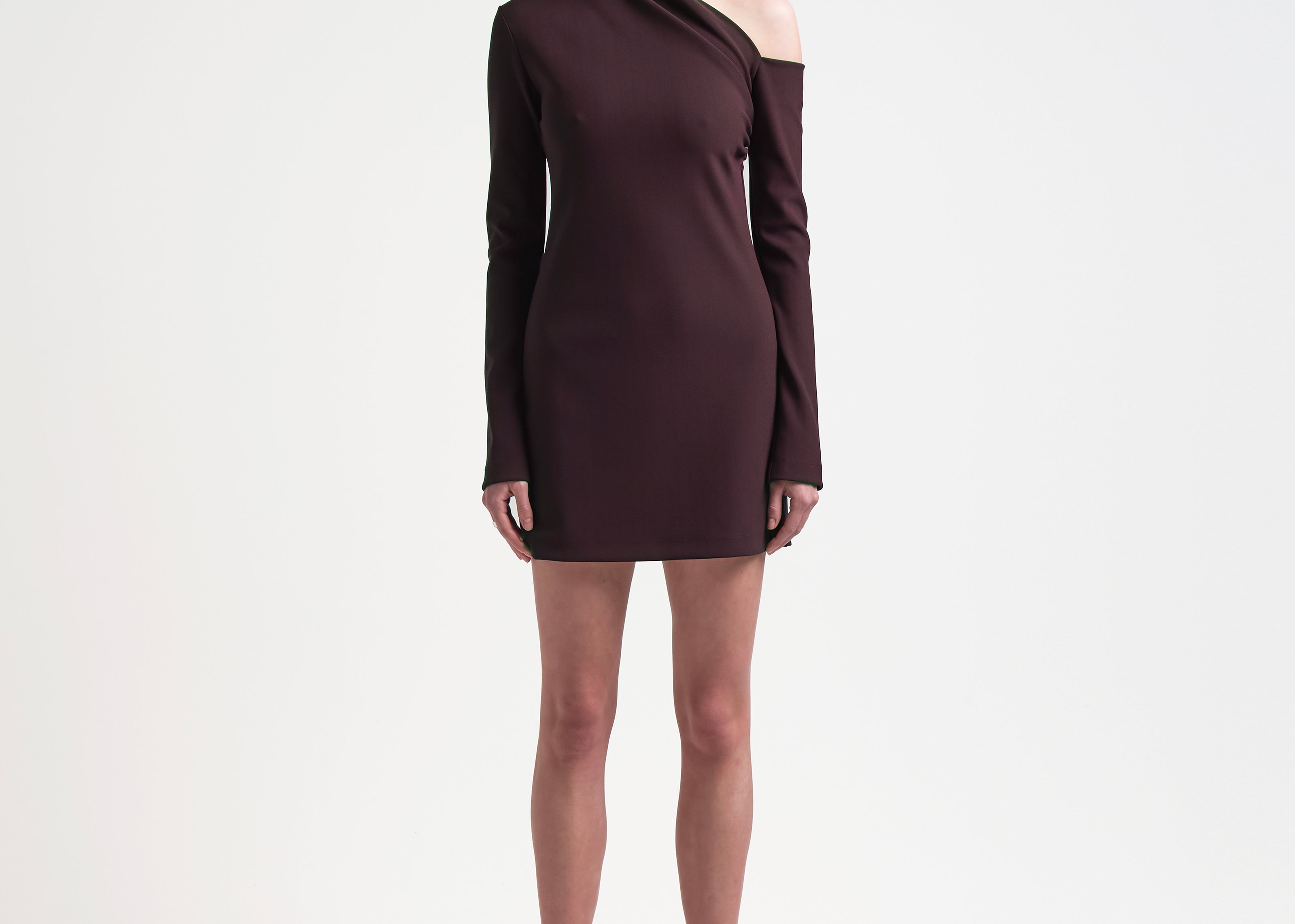 sener besim asymmetric mini dress with long sleeves worn by model 