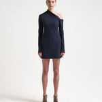 A model wearing a navy asymmetric neckline, long-sleeved, mini-length dress by sener besim
