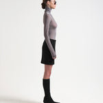 model side view wearing knee length sener besim black pencil skirt 