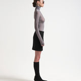 model side view wearing knee length sener besim black pencil skirt 