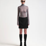 model wearing high waist bonded mini skirt in black by sener besim