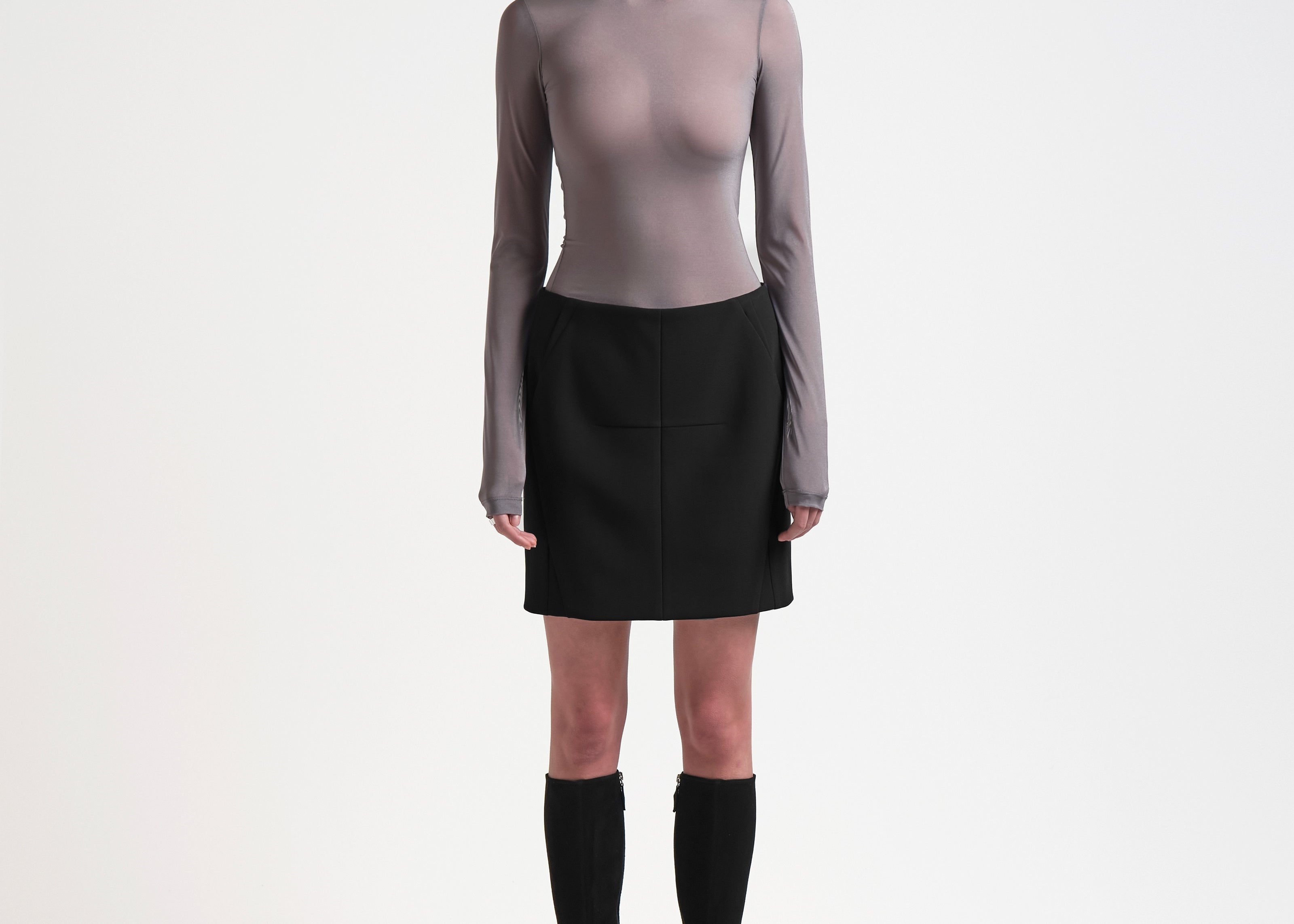 model wearing high waist bonded mini skirt in black by sener besim