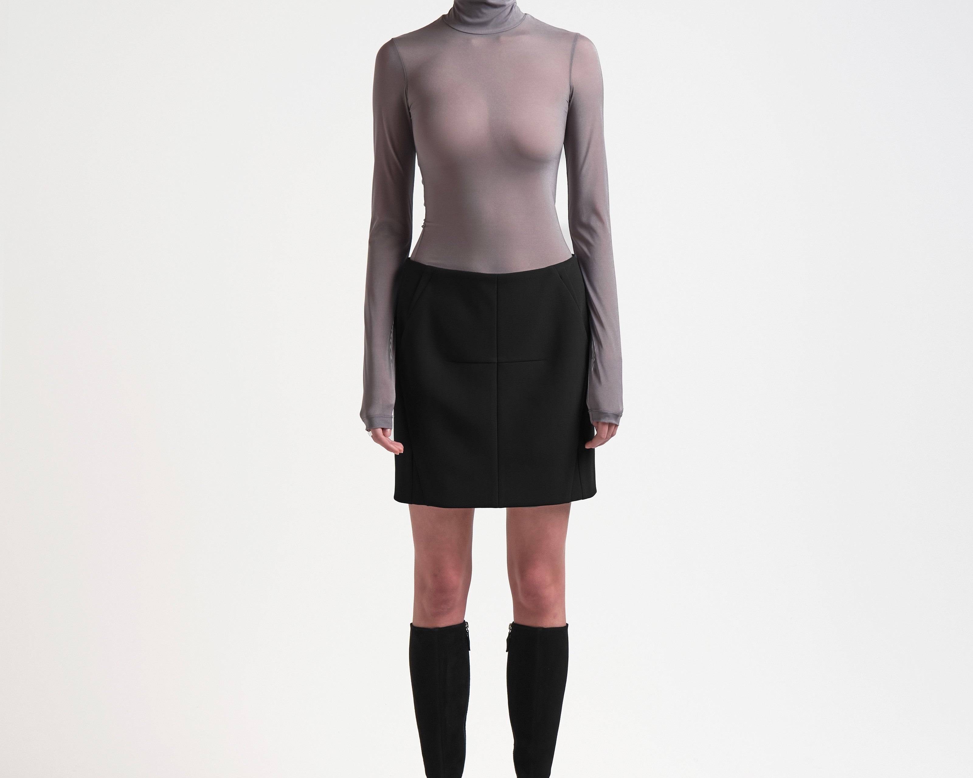 model wearing high waist bonded mini skirt in black by sener besim