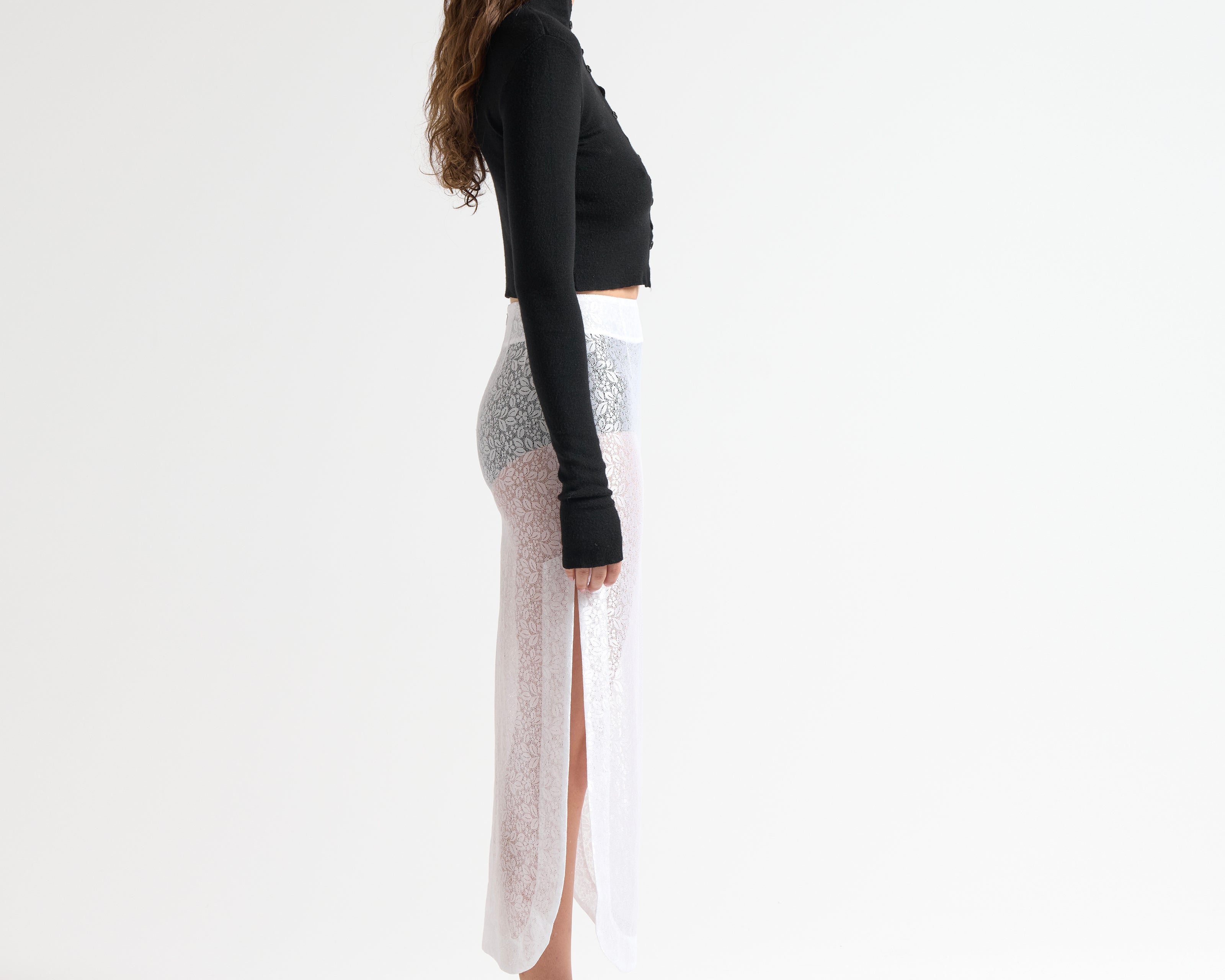 Black cropped knit cardigan with button-through front and thumbhole detail — Şener Besim