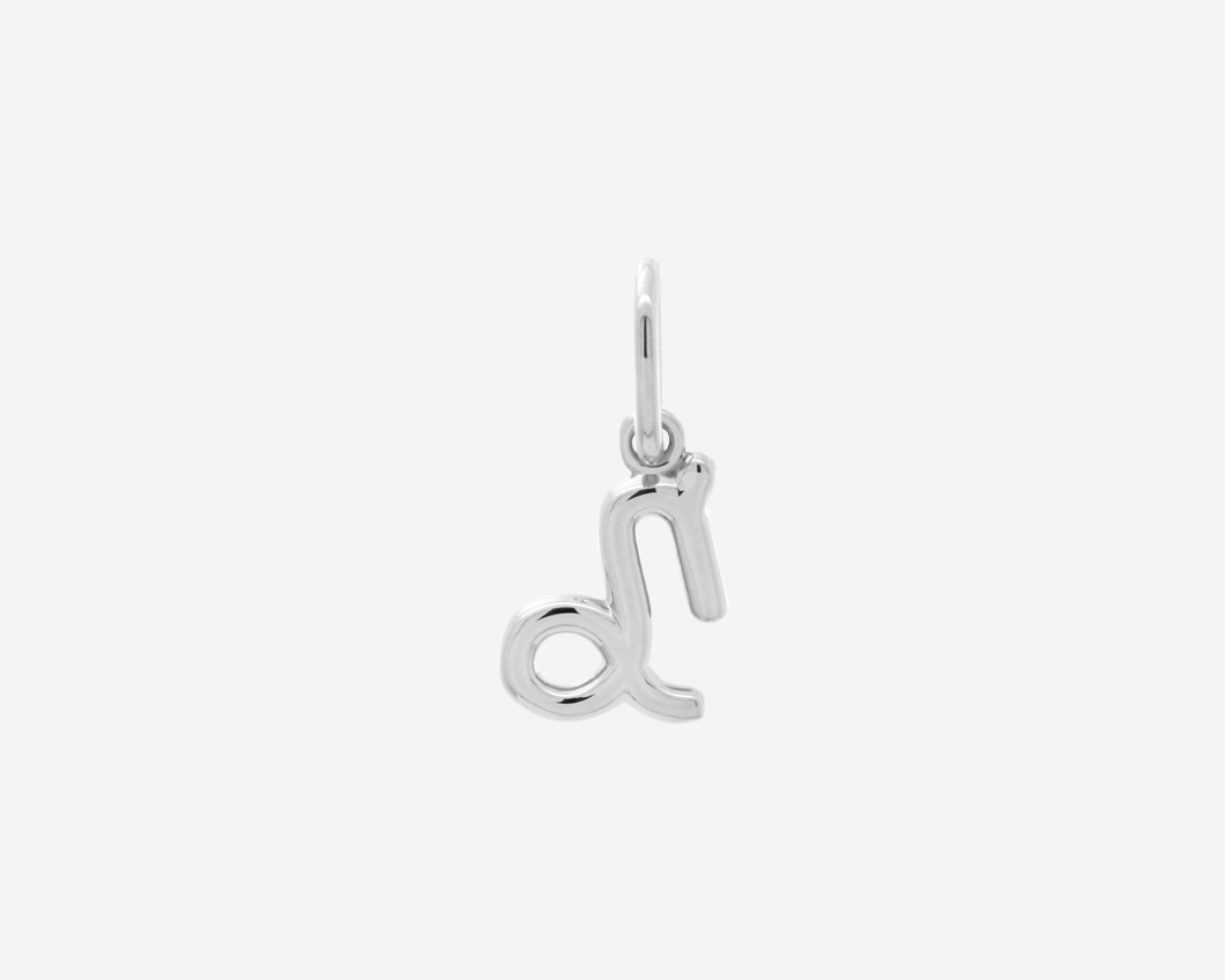 Şener Besim Capricorn Charm in silver rhodium plating, flat lay