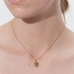 Şener Besim Clover Charm worn on necklace — sterling silver