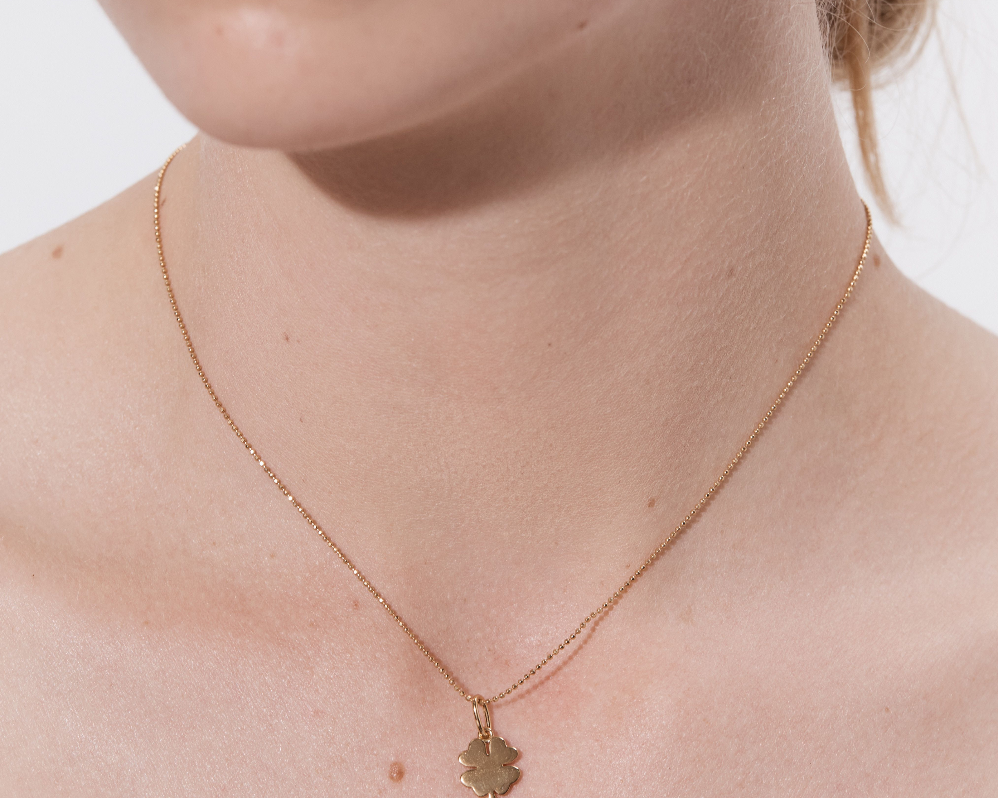 Şener Besim Clover Charm worn on necklace — sterling silver