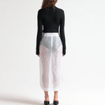 Merino wool cropped cardi in black, styled with sheer midi skirt, front view — Şener Besim