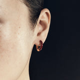 Şener Besim Enamel Huggie burgundy gold worn on ear, editorial shot