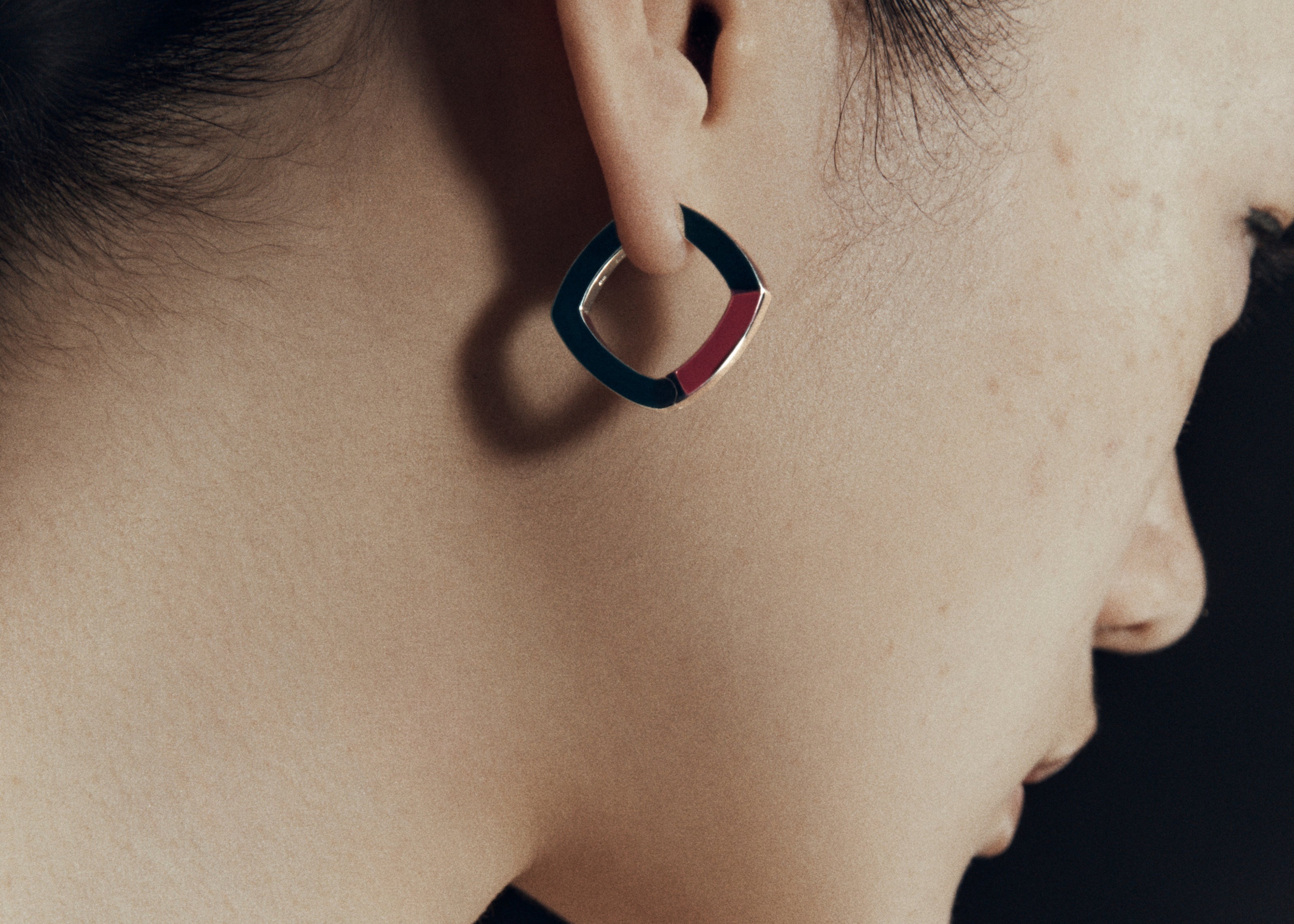 Burgundy enamel thick accent hoop earrings worn on ear — Şener Besim