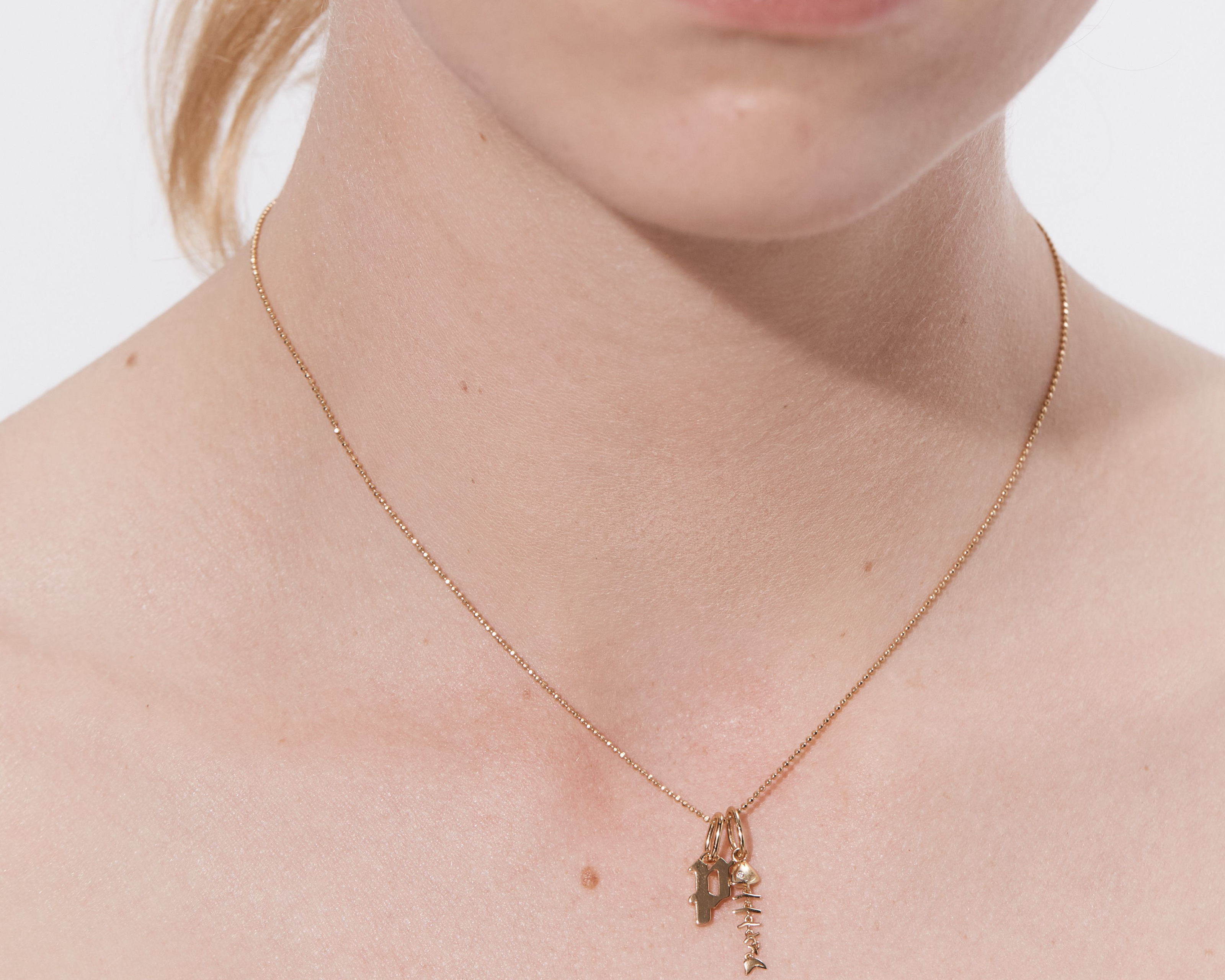 Alt: Şener Besim Fish Charm worn on necklace — sterling silver
