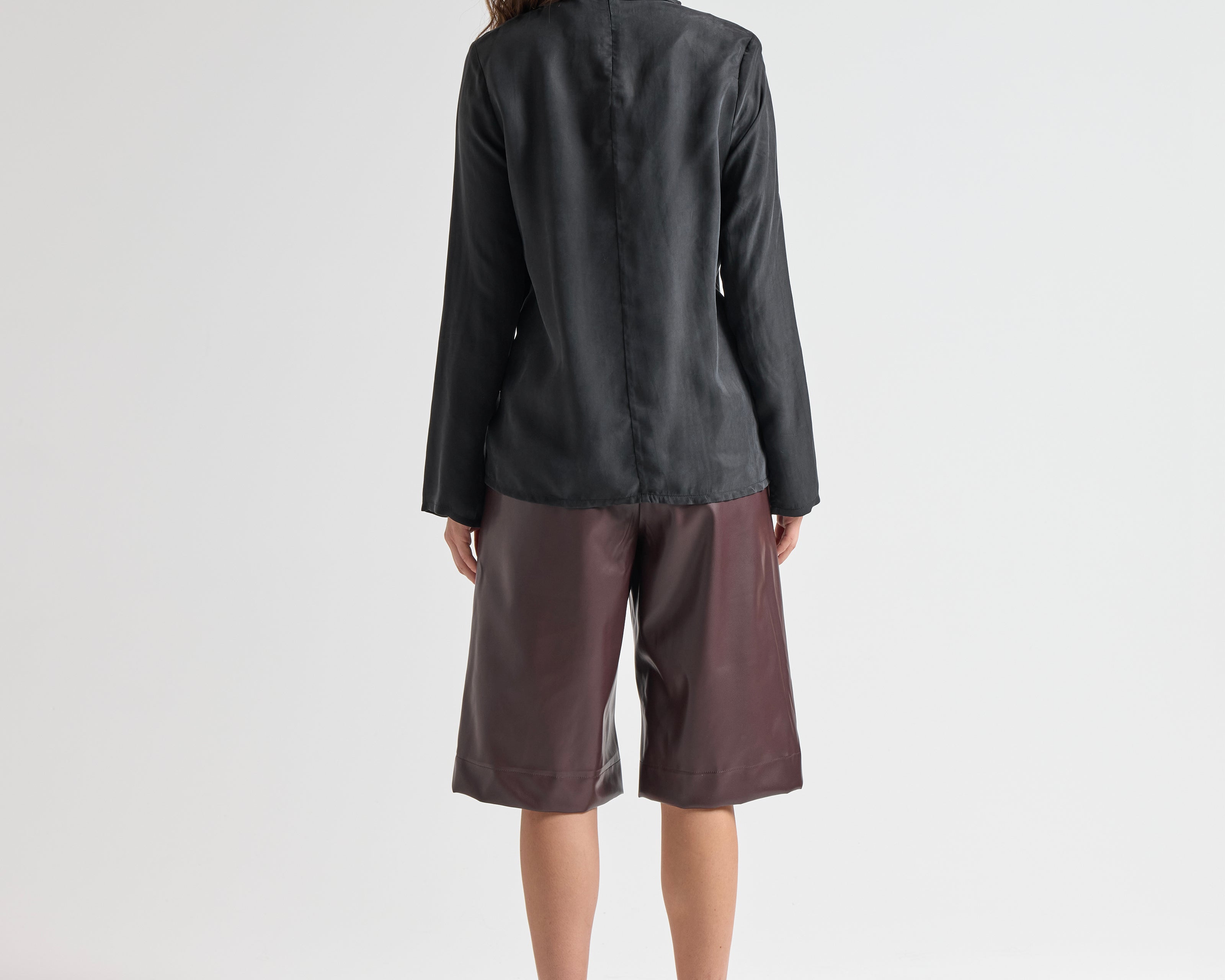 model wearing high neck blouse in black by sener besim