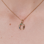 Şener Besim Horseshoe With Gems Charm worn as a necklace pendant