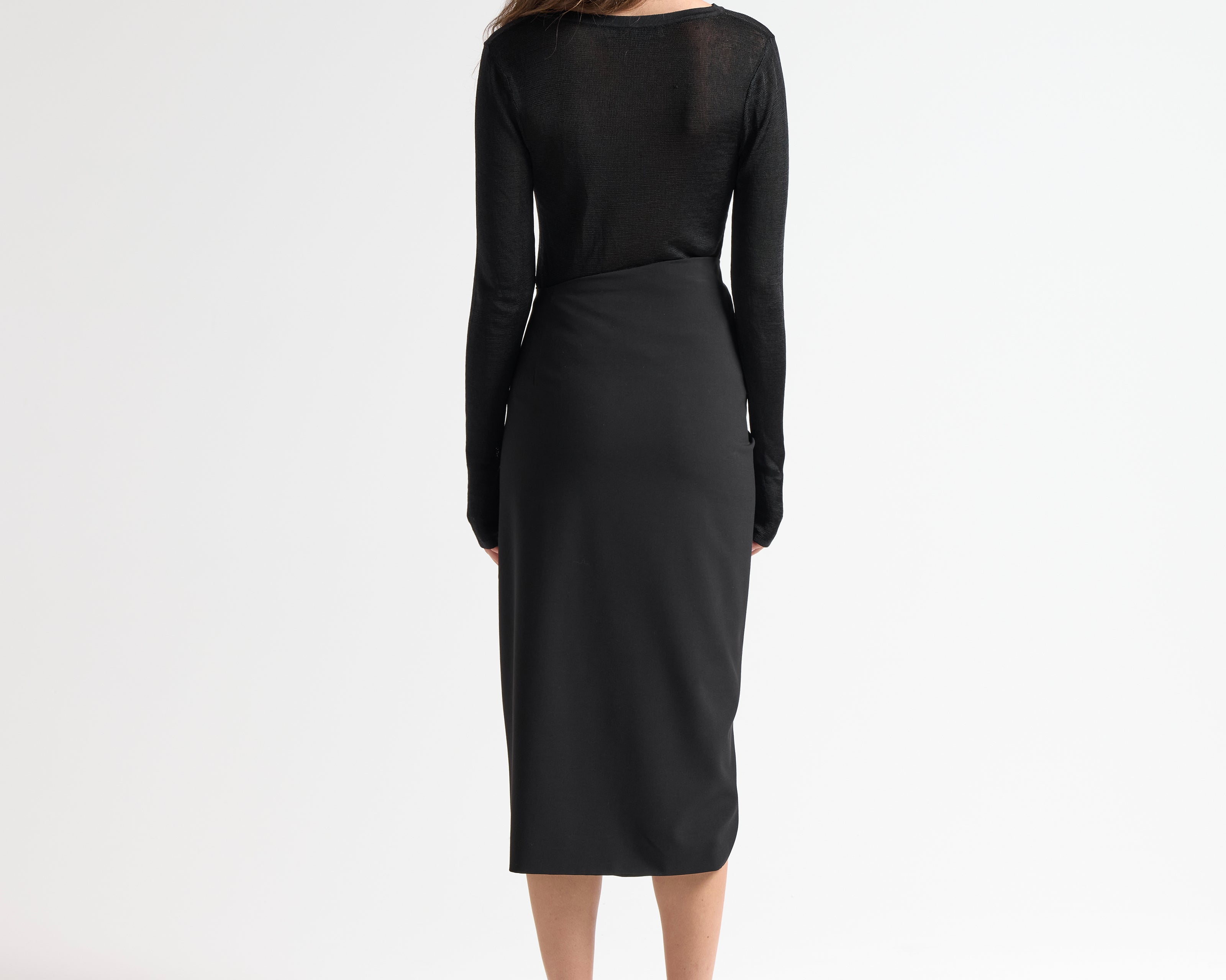 model wearing insert skirt with asymmetric waist and ruching detail by sener besim