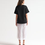 model back view of knitted oversized tee by sener besim