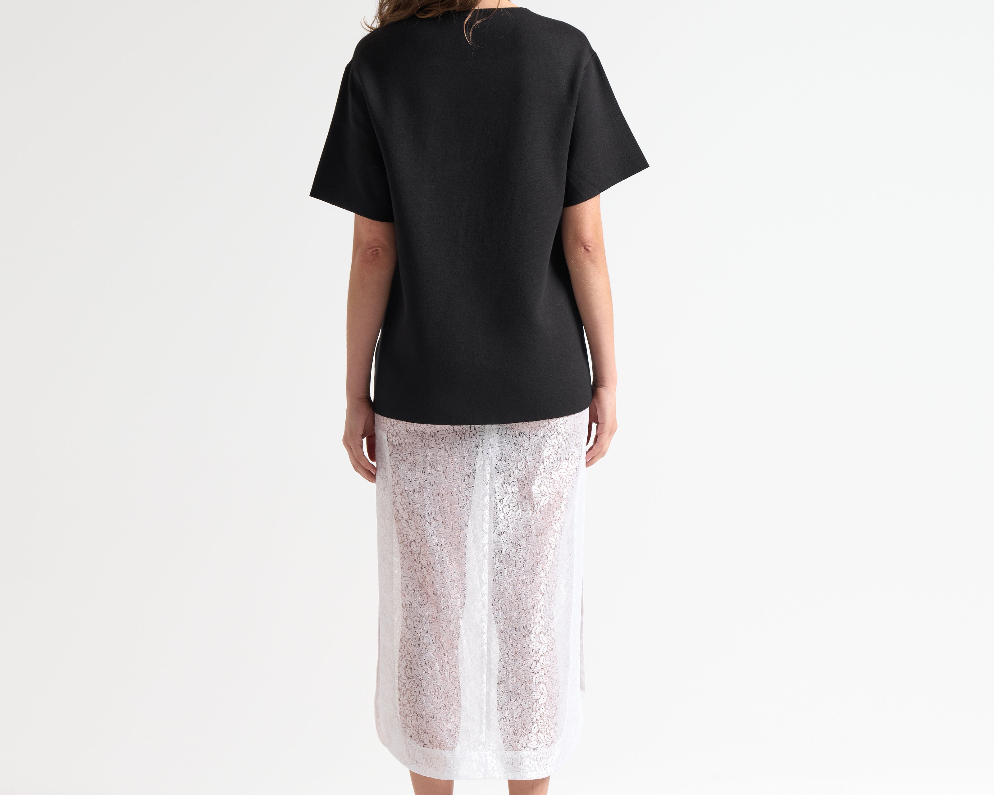 model back view of knitted oversized tee by sener besim
