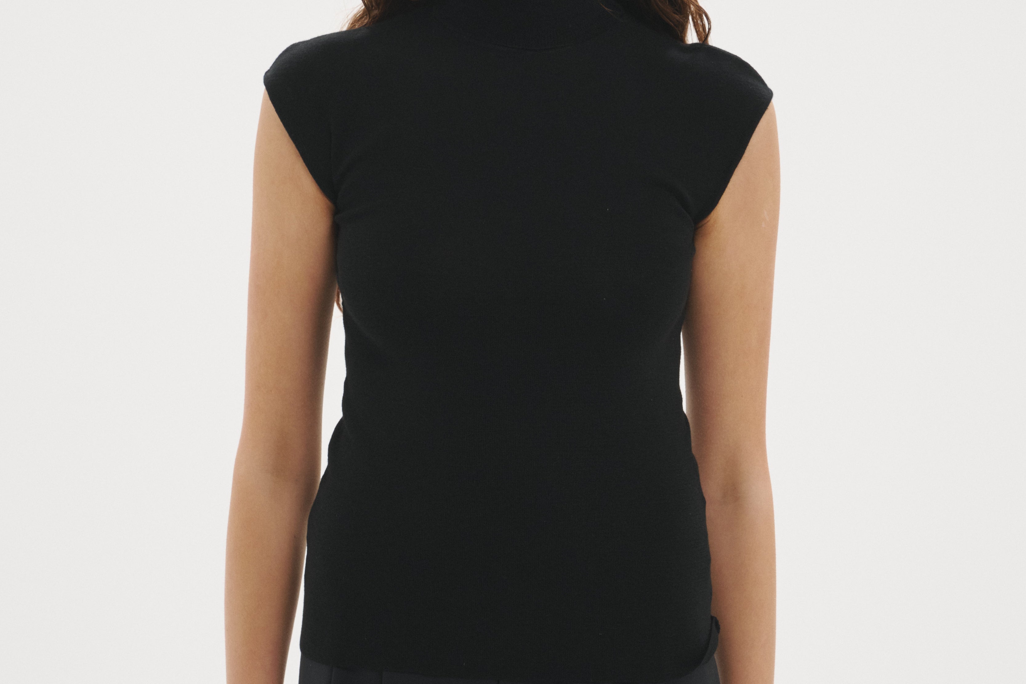 Şener Besim Merino Cap Sleeve Top in Black, styled with black wide-leg trousers