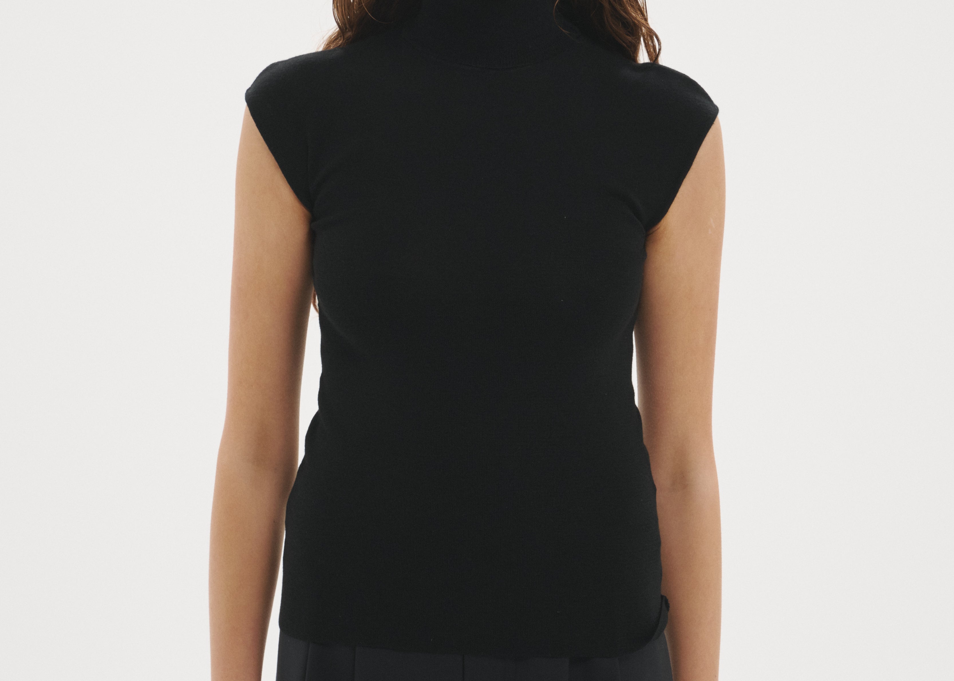 Şener Besim Merino Cap Sleeve Top in Black, styled with black wide-leg trousers