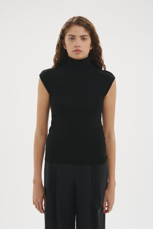 Şener Besim Merino Cap Sleeve Top in Black, styled with black wide-leg trousers