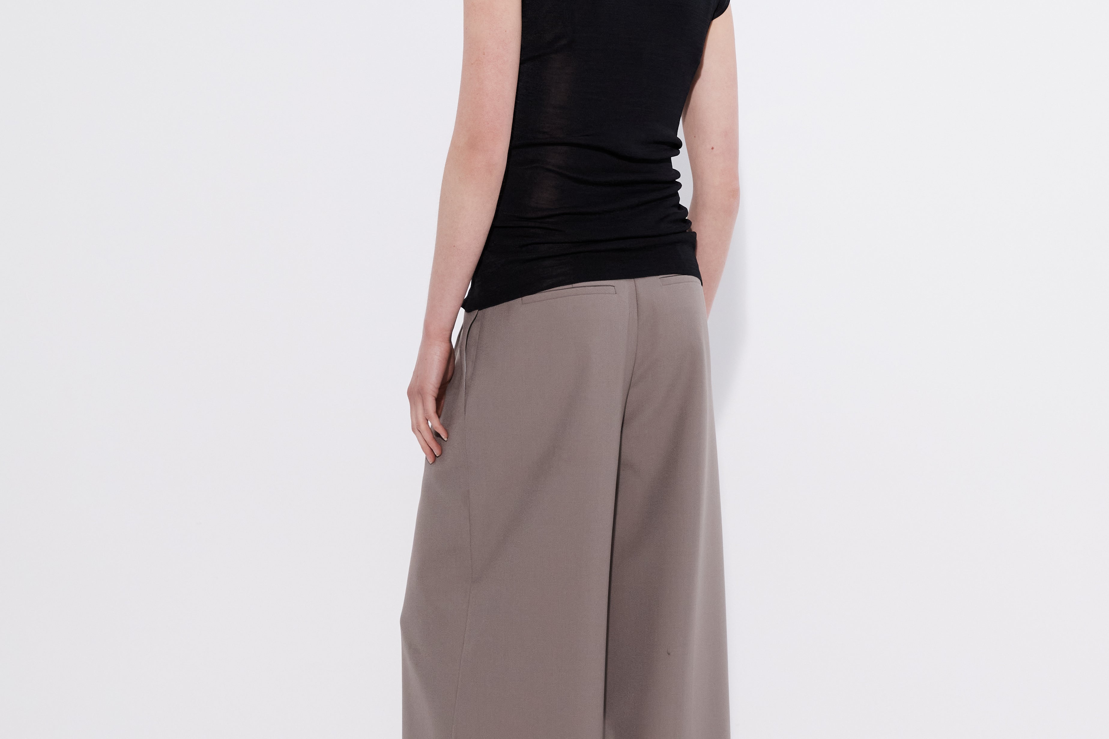 Black merino cap sleeve turtleneck top, back view — Şener Besim