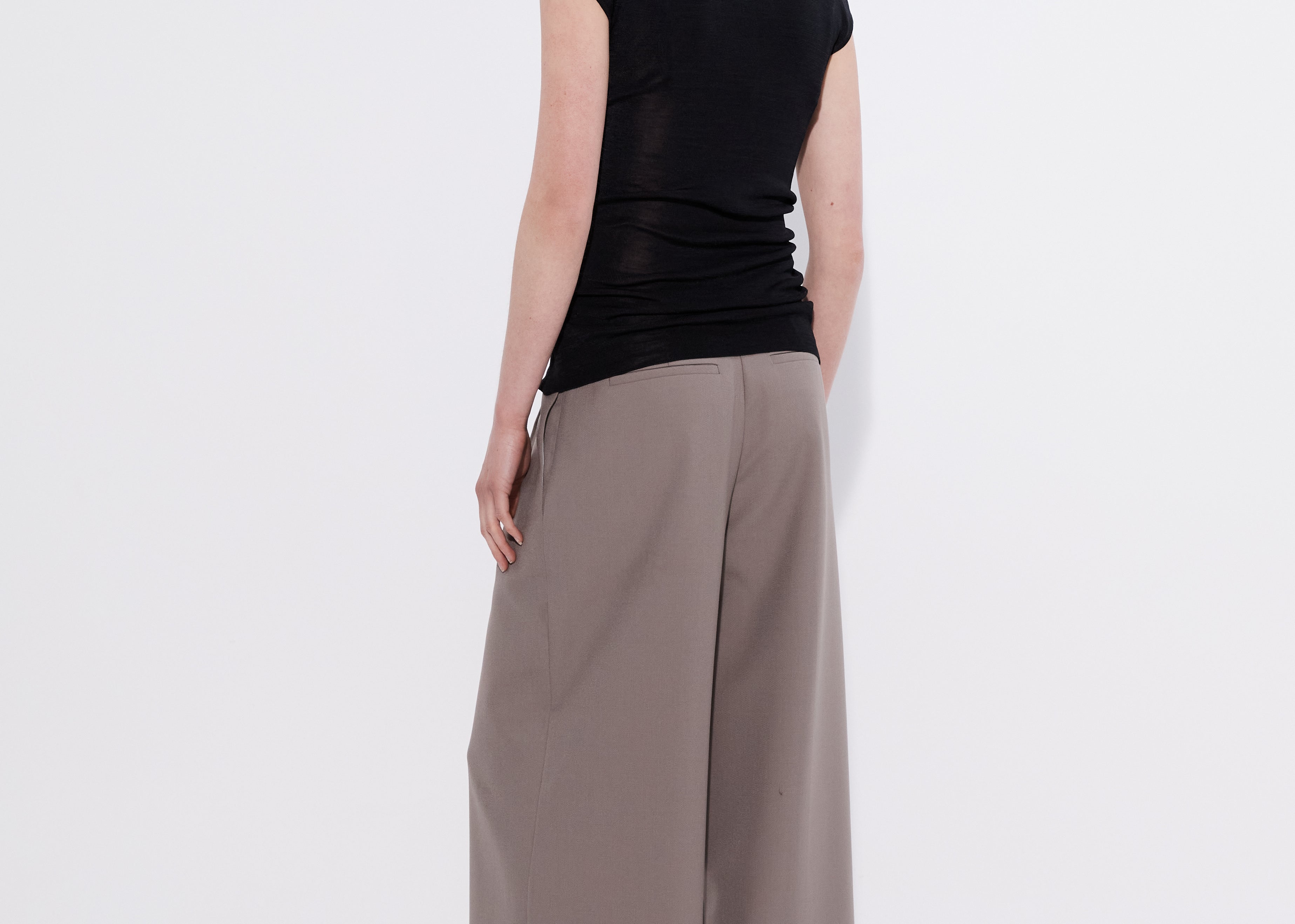 Black merino cap sleeve turtleneck top, back view — Şener Besim