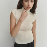 Şener Besim Merino Cap Sleeve Top in White, close-up showing the high turtleneck