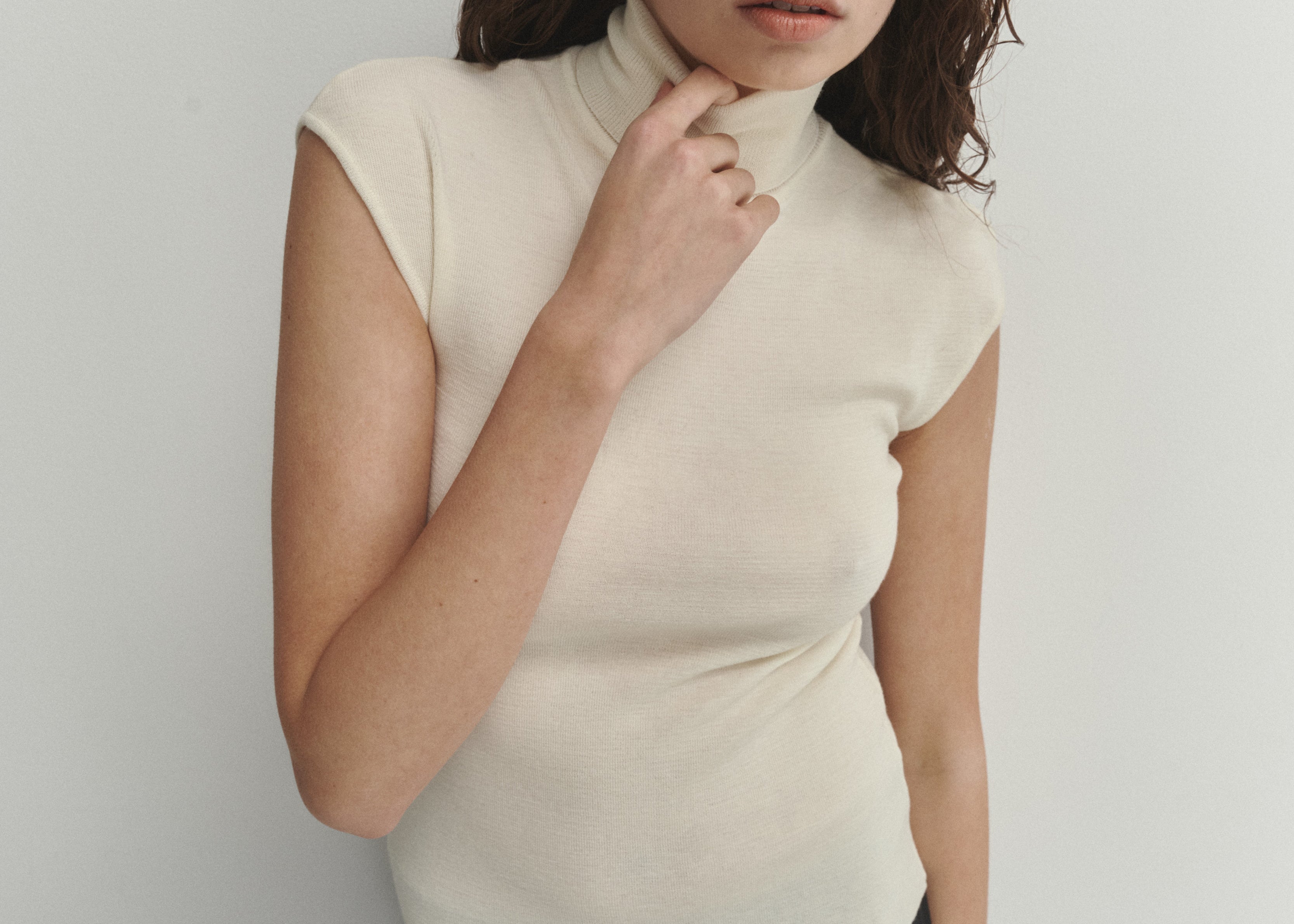 Şener Besim Merino Cap Sleeve Top in White, close-up showing the high turtleneck