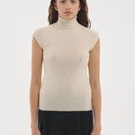Şener Besim Merino Cap Sleeve Top in White, styled with black wide-leg trousers
