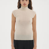 Şener Besim Merino Cap Sleeve Top in White, styled with black wide-leg trousers