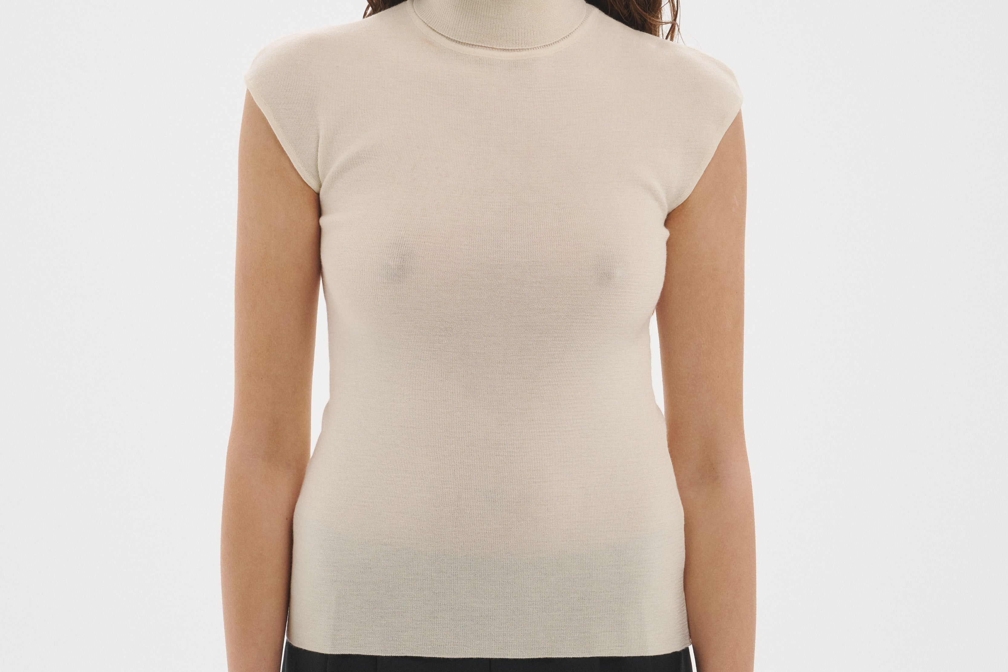 Şener Besim Merino Cap Sleeve Top in White, styled with black wide-leg trousers